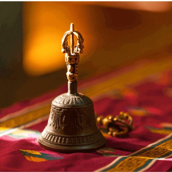 Bell on red decorated fabric
