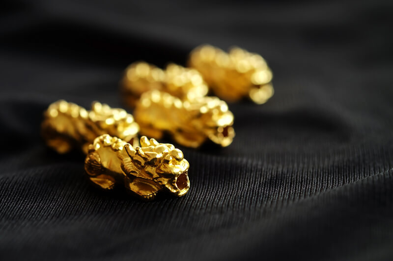 Pixiu golden beads on black fabric